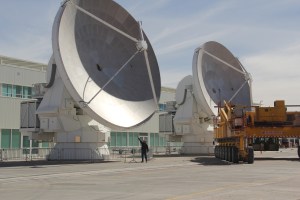 A 12-meter antenna, with Brian for scale. Credit: Tim Spuck